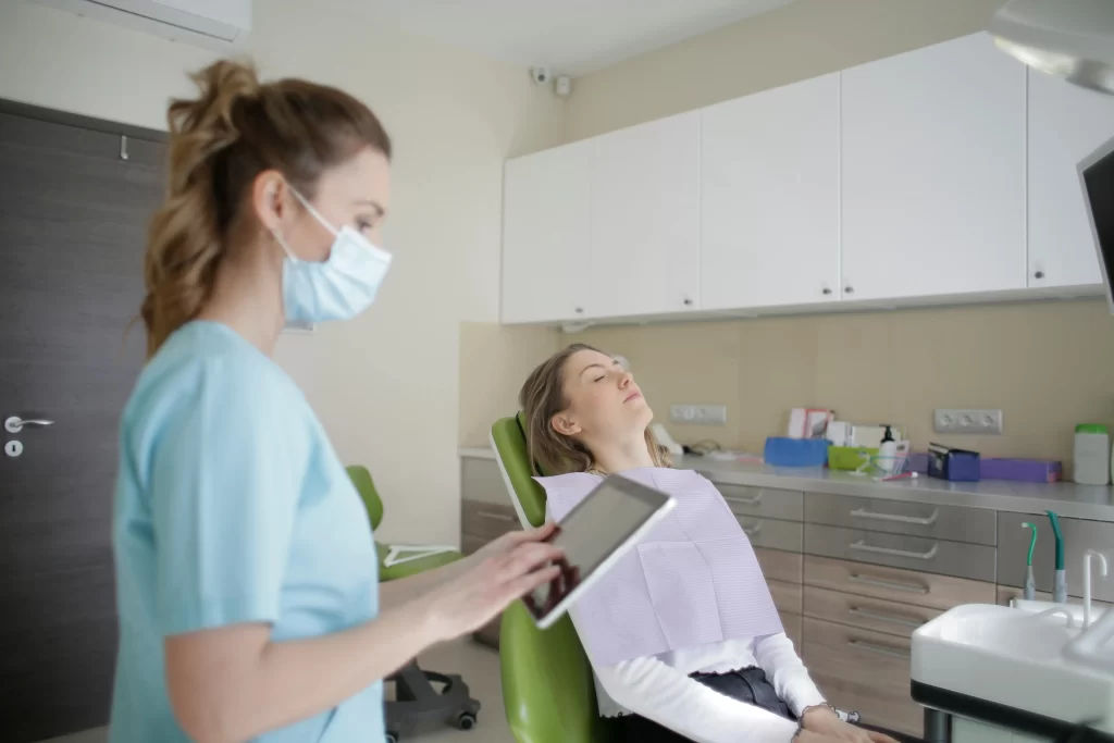 Dentist Using Tablet App to Help With Job