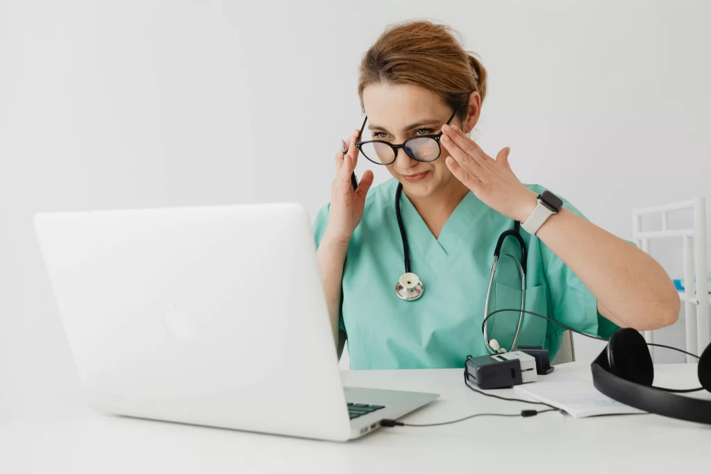 Doctor Sat Down In Front of Laptop to Help People Remotely