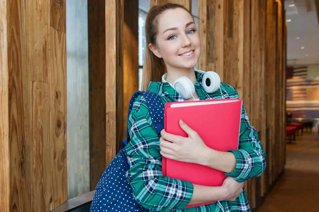 Happy Student Holding Notebook